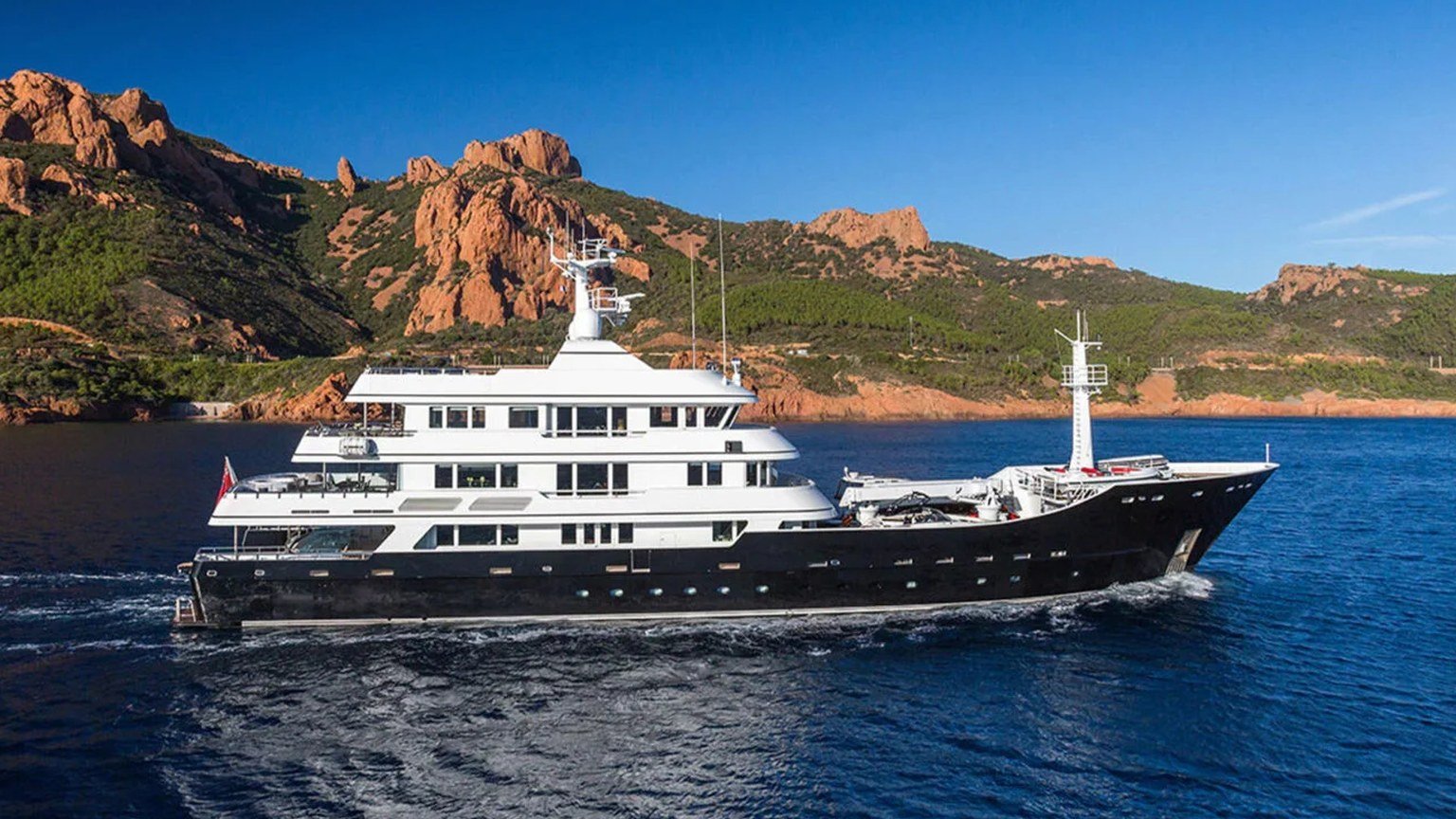 Grand Rusalina under way along a rocky coast after her refit