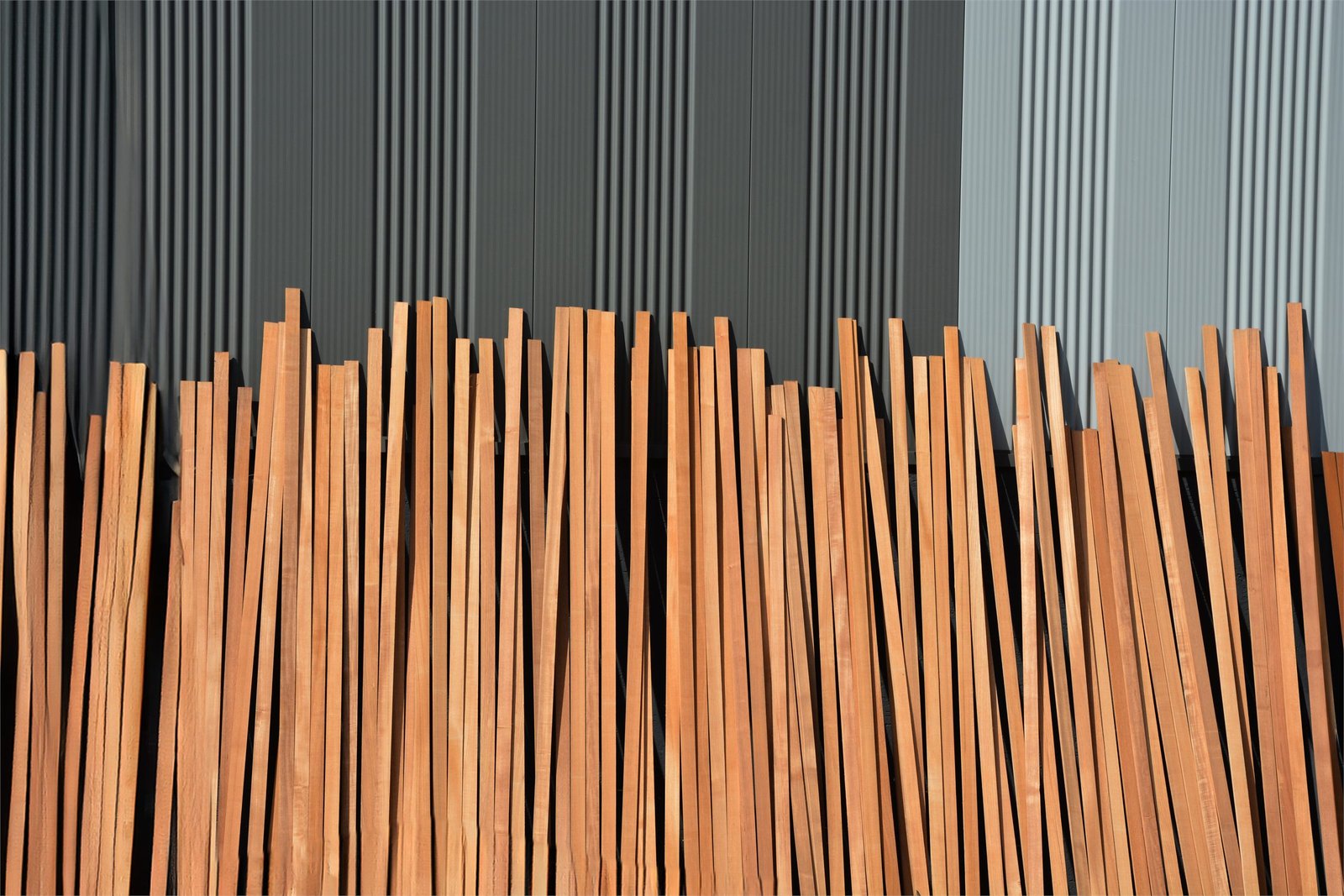 Timber battens stacked against the shed wall