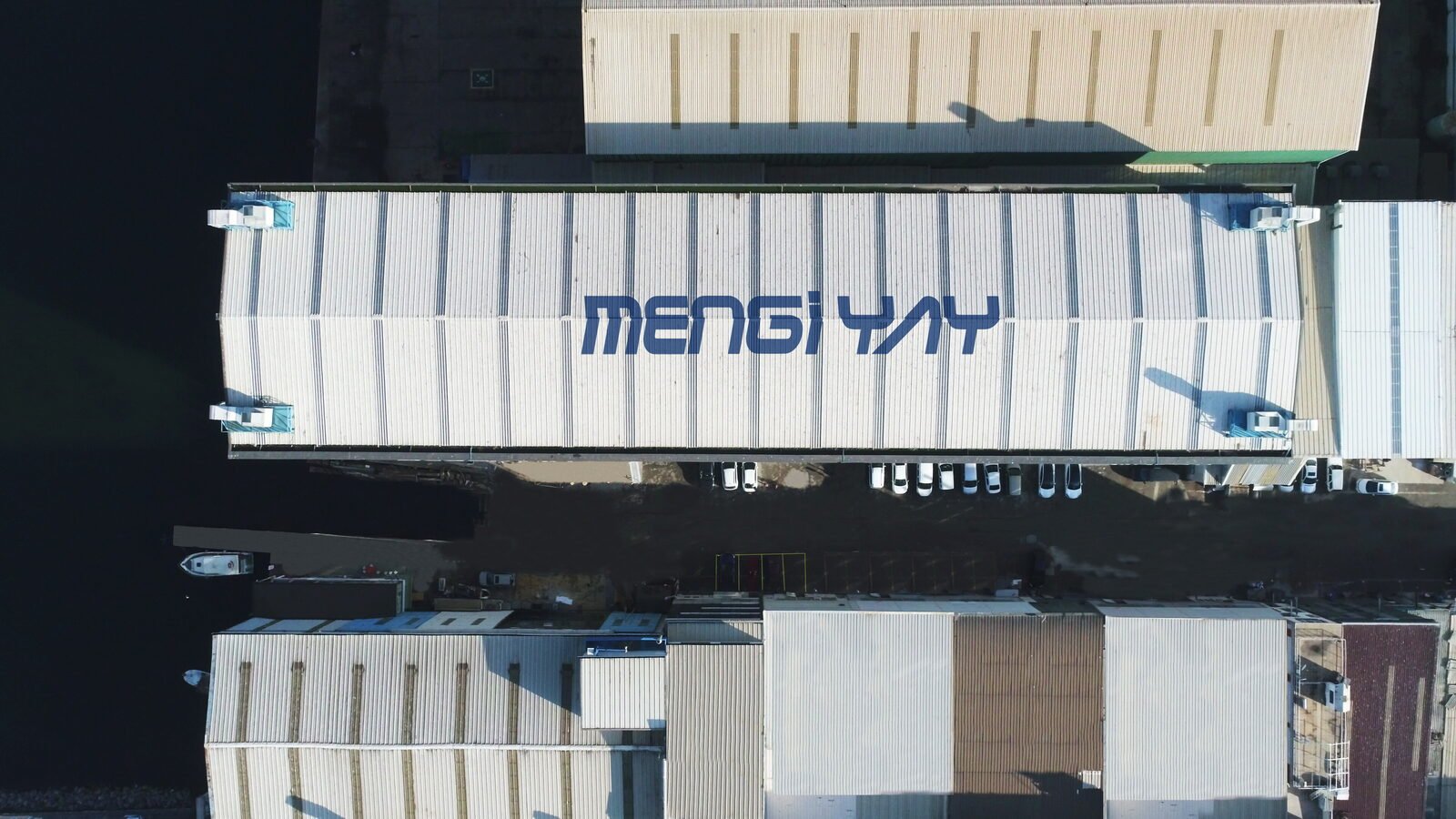 Aerial view of the covered refit halls at the Mengi Yay yard in Tuzla, yacht hulls standing ashore alongside them
